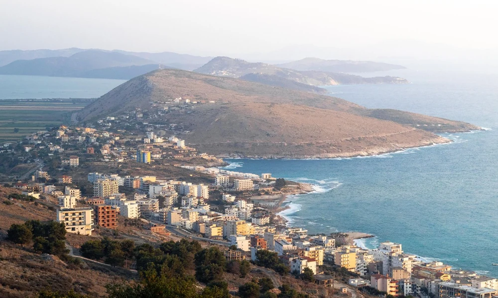 View of Saranda from above, houses on the hillside and the bay