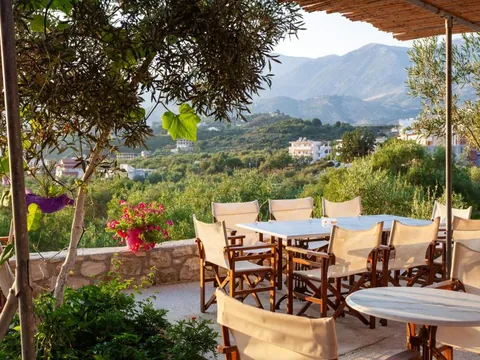 The breakfast terrace under the olive tree at Toni Retzo Rooms in Himara
